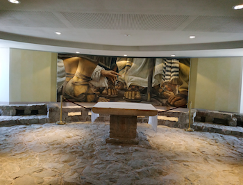 Fig. 3. Encounter Chapel at the modern prayer house Duc In Altum. The chapel was positioned on top of 1st century port pavement. The interior is modeled after Magdala's synagogue (note the stone benches which reconstruct similar benches discovered in the "vestibule room" of the synagogue). Photograph by the author, 2018.